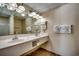 Well-lit bathroom featuring a double sink vanity, large mirror, and tile flooring at 2501 S Ocean Blvd. # 601, Myrtle Beach, SC 29577