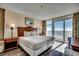 Bright bedroom featuring a queen bed, wood headboard, a balcony with ocean views at 2501 S Ocean Blvd. # 601, Myrtle Beach, SC 29577