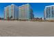 Stunning exterior view of modern high-rise buildings situated on a beautiful sandy beach at 2501 S Ocean Blvd. # 601, Myrtle Beach, SC 29577