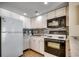 Bright kitchen featuring white appliances, backsplash, and ample cabinet space at 2501 S Ocean Blvd. # 601, Myrtle Beach, SC 29577