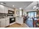 Cozy kitchen with white cabinets, modern appliances and a breakfast bar with ocean view at 2501 S Ocean Blvd. # 601, Myrtle Beach, SC 29577