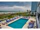 Scenic pool area with ample lounge chairs and umbrellas, surrounded by lush greenery and ocean views at 2501 S Ocean Blvd. # 601, Myrtle Beach, SC 29577