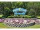 Charming 'Myrtle Beach Welcomes You!' sign surrounded by colorful flowers and lush greenery at 2701 S Ocean Blvd. # 1009, North Myrtle Beach, SC 29582