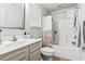 Bright bathroom with a shower-tub combo, white vanity, toilet, and a decorative mirror at 281 Encore Circle, Myrtle Beach, SC 29579