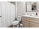 Bathroom with a shower, white vanity, mirror, and a toilet with a grey wall paint at 281 Encore Circle, Myrtle Beach, SC 29579