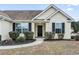 Inviting front entrance featuring a black door with a wreath and manicured landscaping at 281 Encore Circle, Myrtle Beach, SC 29579