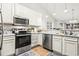 Well-lit kitchen featuring stainless steel appliances, white cabinets, and laminate countertops at 281 Encore Circle, Myrtle Beach, SC 29579