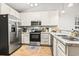 Well-equipped kitchen with stainless steel appliances, white cabinets, and hardwood floors at 281 Encore Circle, Myrtle Beach, SC 29579