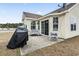 Back patio area with outdoor seating, barbecue grill, and a view of the home's exterior at 281 Encore Circle, Myrtle Beach, SC 29579