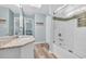 Bright bathroom featuring a granite countertop, modern fixtures, and tiled shower at 299 Lake Arrowhead Rd., Myrtle Beach, SC 29572