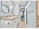 Bathroom featuring double sinks, granite countertops, a shower, and updated fixtures at 299 Lake Arrowhead Rd., Myrtle Beach, SC 29572