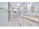 Bathroom featuring double sinks, granite countertops, a shower, and updated fixtures at 299 Lake Arrowhead Rd., Myrtle Beach, SC 29572