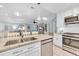 Open kitchen with stainless steel appliances, granite counters, and seamless flow to living area at 299 Lake Arrowhead Rd., Myrtle Beach, SC 29572