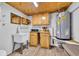 Laundry room with a sink, wood cabinets, granite countertops, and a water heater at 299 Lake Arrowhead Rd., Myrtle Beach, SC 29572