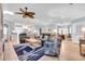 Spacious living room with modern furnishings, light blue walls, a ceiling fan, and lots of natural light at 299 Lake Arrowhead Rd., Myrtle Beach, SC 29572