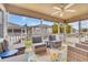 Relaxing screened-in porch with cozy seating, a ceiling fan, and views of the peaceful surroundings at 299 Lake Arrowhead Rd., Myrtle Beach, SC 29572