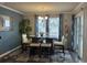 Dining area with dark wood table, cream cushions, modern chandelier, and sliding glass doors at 3009 Woodbury Ct., Conway, SC 29527