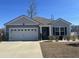 Lovely one-story house with a well-maintained lawn, attached garage, and a welcoming entrance at 3009 Woodbury Ct., Conway, SC 29527