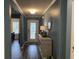 Hallway featuring decorative mirror and accent furniture leading into a bright living space at 3009 Woodbury Ct., Conway, SC 29527