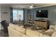 Cozy living room featuring neutral furniture, a large window, decorative ladder and TV at 3009 Woodbury Ct., Conway, SC 29527