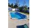 Sparkling in-ground pool with concrete surround, metal ladder, and white fence at 3009 Woodbury Ct., Conway, SC 29527