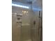 Modern shower with glass door, tile surround, shower niche, and rainfall shower head at 3009 Woodbury Ct., Conway, SC 29527