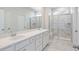 Bathroom featuring double sink vanity, marble flooring, and glass shower at 3011 Visionary Dr., Myrtle Beach, SC 29588