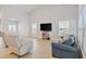 Bright living room with vaulted ceiling, hardwood floors, large windows, and comfortable seating at 3011 Visionary Dr., Myrtle Beach, SC 29588