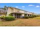 View of the backyard with a screened porch and manicured shrubbery at 306 Kiskadee Loop # 4-F, Conway, SC 29526