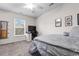 Bright bedroom featuring a ceiling fan, large window, desk, and neutral walls at 306 Kiskadee Loop # 4-F, Conway, SC 29526