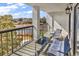 Relaxing balcony with seating offers lovely views of the lake and surrounding mature trees at 311 69Th Ave. N # 404, Myrtle Beach, SC 29572