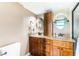 Well-lit bathroom features double sinks with granite counters and traditional wood cabinets at 311 69Th Ave. N # 404, Myrtle Beach, SC 29572