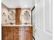 Bathroom featuring double sinks with granite countertops and wooden cabinets at 311 69Th Ave. N # 404, Myrtle Beach, SC 29572