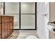 Bathroom with tiled shower and glass door, contrasting with the warm wood tones of the vanity at 311 69Th Ave. N # 404, Myrtle Beach, SC 29572