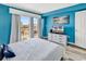 Bedroom boasts a balcony, sliding glass doors, and a lovely blue accent wall at 311 69Th Ave. N # 404, Myrtle Beach, SC 29572