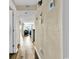 A hallway with wood floors leads to a living room featuring neutral wall colors and nautical themed artwork at 311 69Th Ave. N # 404, Myrtle Beach, SC 29572