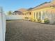 Backyard view including a home with brick exterior, covered patio, a grill and a white fence at 311 Las Olas Dr., Myrtle Beach, SC 29577