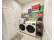 Laundry Room with a washer, dryer, wire shelving, grey walls and a door at 311 Las Olas Dr., Myrtle Beach, SC 29577