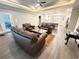 Spacious living room with tray ceiling, ceiling fan, and luxury vinyl plank flooring at 311 Las Olas Dr., Myrtle Beach, SC 29577