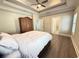 Relaxing main bedroom with wood-look flooring, tray ceiling, and ensuite bathroom at 311 Las Olas Dr., Myrtle Beach, SC 29577