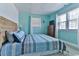 Bright bedroom offers light colored walls, a comfortable bed, and natural light at 317 23Rd Ave. N, North Myrtle Beach, SC 29582