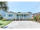 Charming single-story beach home with a cozy front porch, well-manicured lawn, and ample parking space at 317 23Rd Ave. N, North Myrtle Beach, SC 29582