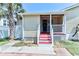 Cozy front porch featuring stairs that lead to the access door of the home at 317 23Rd Ave. N, North Myrtle Beach, SC 29582