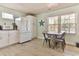 Well-lit dining area with a modern table, seamlessly connected to a fully equipped kitchen, ready for entertaining at 317 23Rd Ave. N, North Myrtle Beach, SC 29582