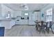 Spacious eat-in kitchen with white cabinets, a full suite of appliances, and a modern dining set at 317 23Rd Ave. N, North Myrtle Beach, SC 29582