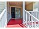 Rear porch showing the access door to the home and the colorful red deck at 317 23Rd Ave. N, North Myrtle Beach, SC 29582