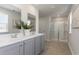 Modern bathroom with double vanity, quartz countertops, and a glass-enclosed shower at 348 Rookroost Circle, Conway, SC 29526