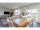 Bright open concept dining area with wood table, white chairs, and view to the living room at 348 Rookroost Circle, Conway, SC 29526