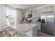 Modern kitchen featuring granite countertops, stainless steel appliances, and gray cabinetry at 348 Rookroost Circle, Conway, SC 29526