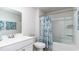 Well-lit bathroom with a shower-tub combination featuring a blue patterned curtain, toilet, and vanity with a mirror at 352 Rookroost Circle, Conway, SC 29526